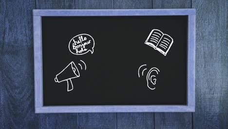 multiple school concept icons on black board