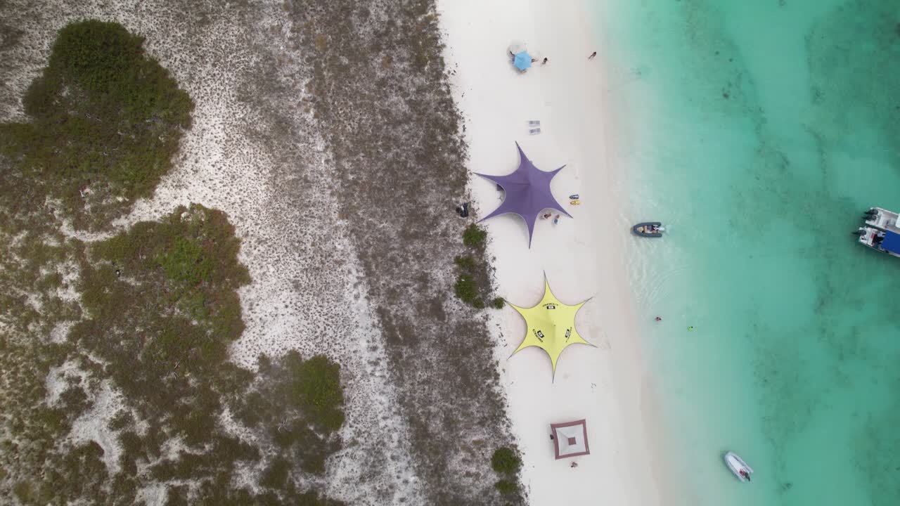 Kites, camp awnings and surfers at Crasqui Island, Los Roques
