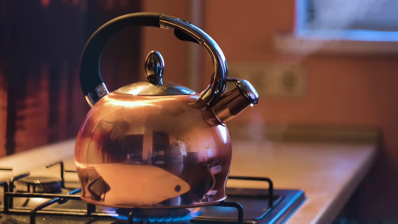 Copper Kettle Boiling on a Gas Stove
