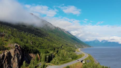 4k drone video of alaska route 1 at base of mountain along shoreline of turnagain inlet near anchorage during summer