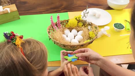 mother and daughter decorating easter eggs