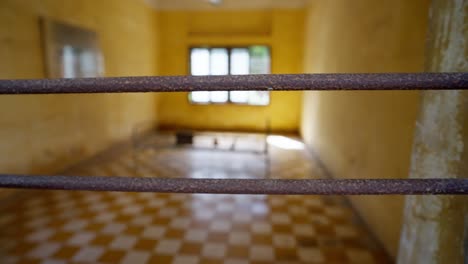 abandoned genocide cell seen through steel bars evokes haunting historic pain