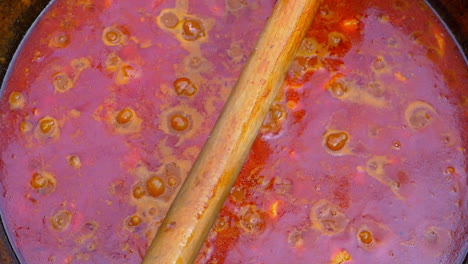 slow-motion-of-traditional-Hungarian-goulash-boiling-in-a-black-cauldron