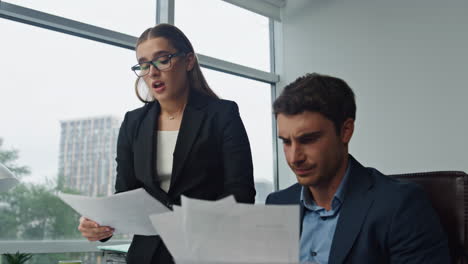 Managers-team-analysing-report-working-computer-closeup.-Two-upset-employees