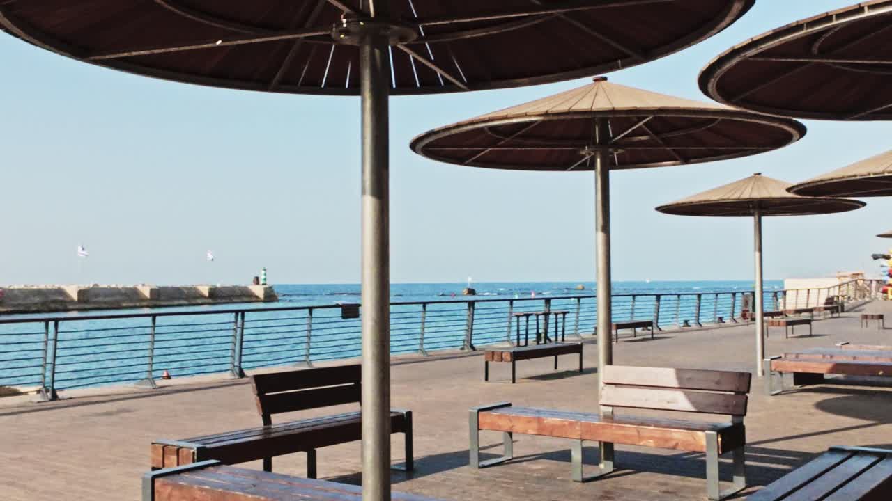 Artistic Wooden Umbrellas Providing Shade On Tel Aviv Coastline