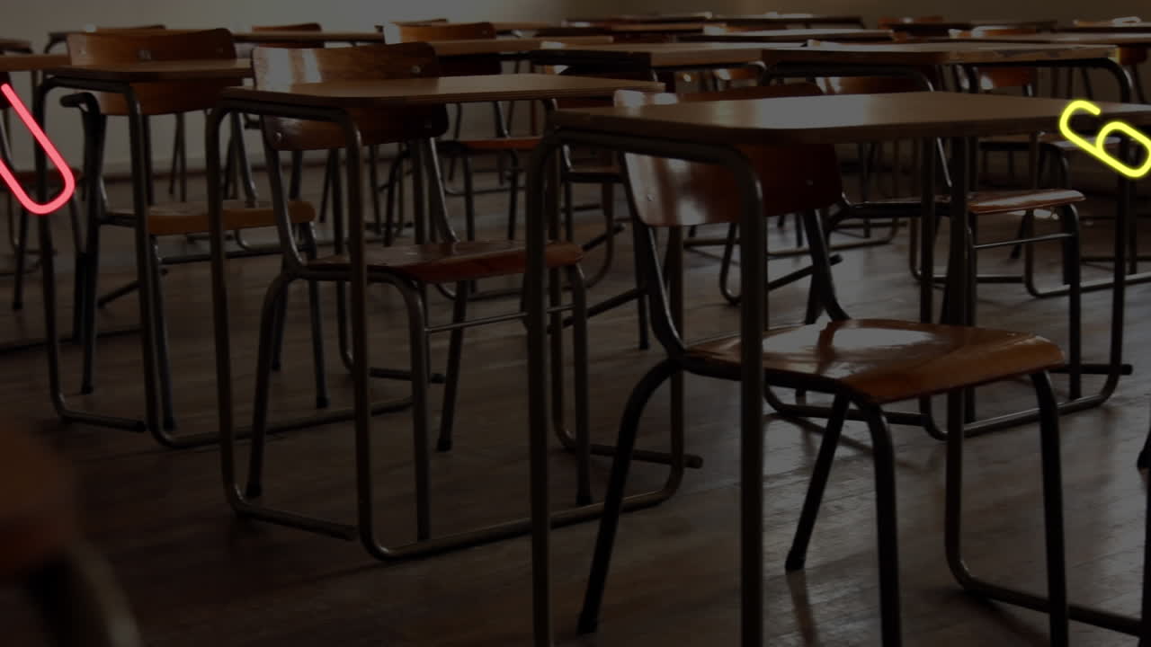 Digital composition of changing numbers and alphabets floating against empty classroom