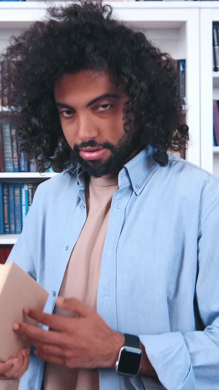A man explores ancient texts in a quiet library during a cozy afternoon