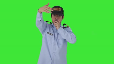 Indian-security-guard-calling-someone-by-using-whistle-Green-screen