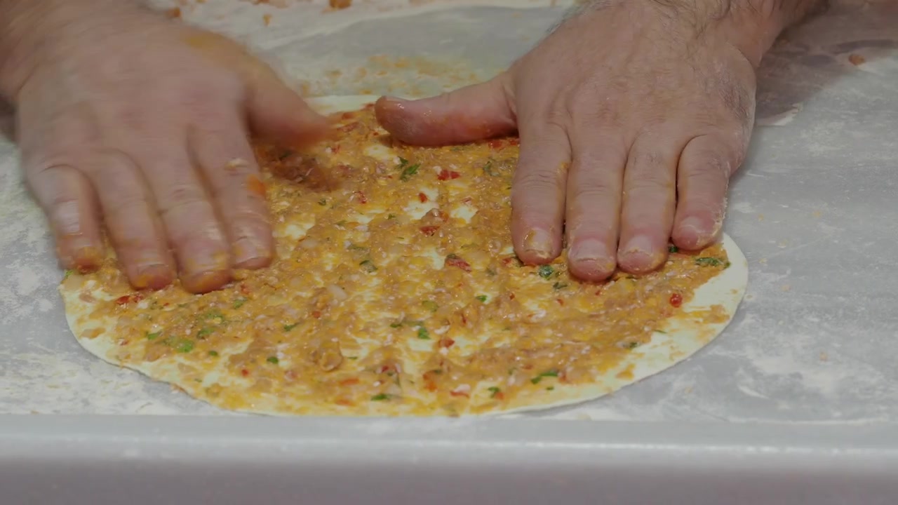 Chef Spreading Meat Topping on Lahmacun Dough