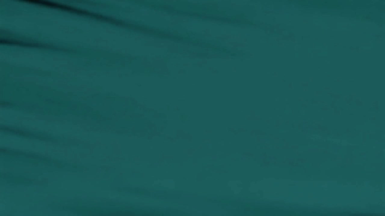 Abstract Teal Fabric Waving in the Dark