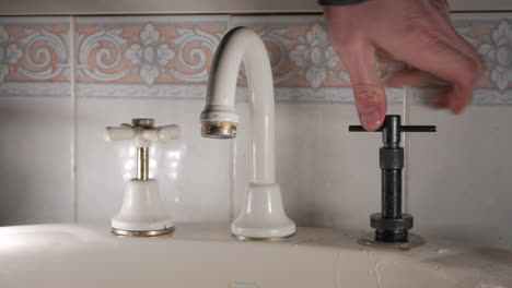 handyman reseats a household faucet