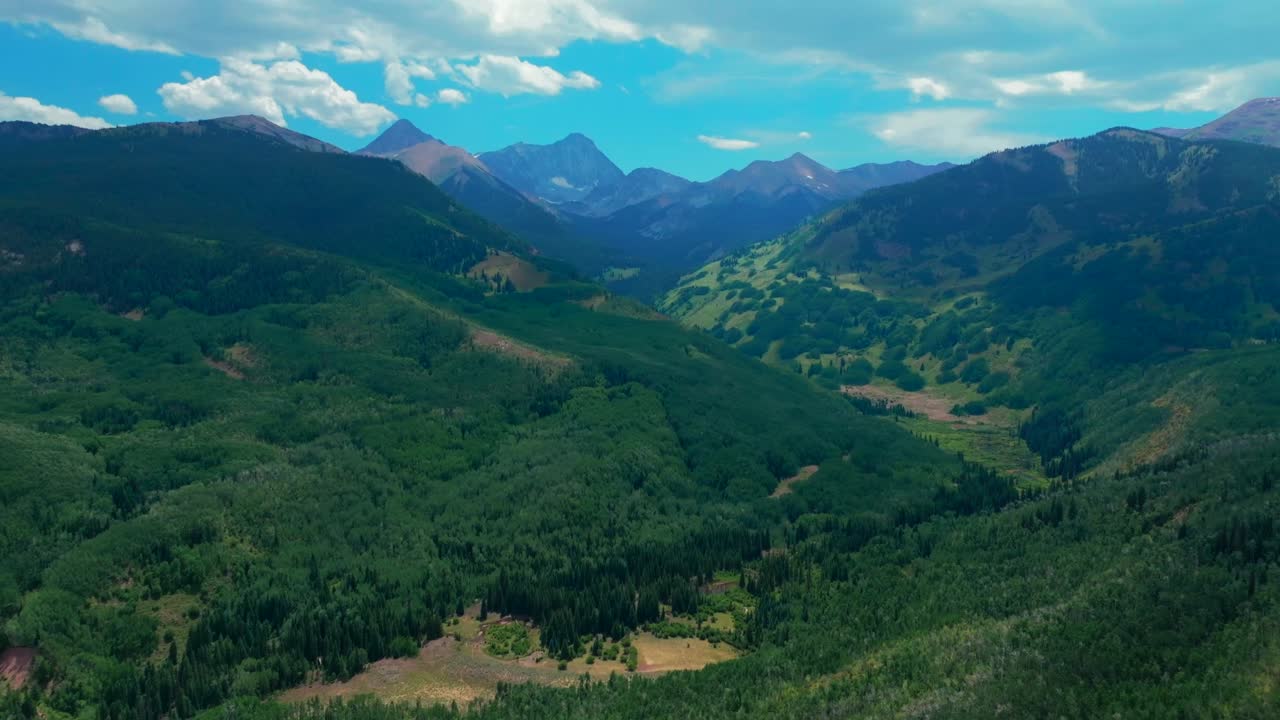 Capitol Peak Wilderness Capitol creek ditch trailhead spring summer 14er aerial drone Colorado Aspen Snowmass Elk Rocky Mountains Range Aspen grove White River Forest sunny blue sky circle right pan