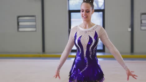 teenage female gymnast performing at sports hall