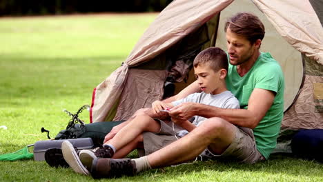 Father-explaining-how-a-compass-works-to-his-son