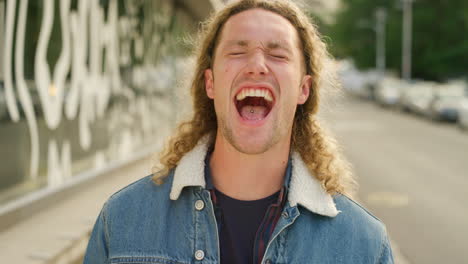 portrait of laughing man showing playful facial