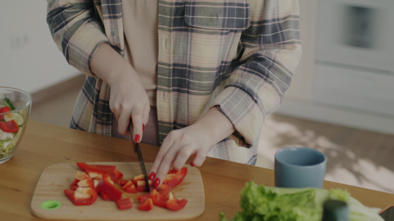 Woman Cooking Salad in Kitchen