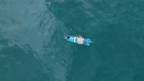 aerial top down drone view of small fishing boat at sea el tunco el salvador