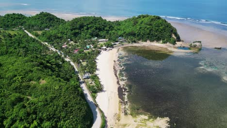 aerial view of scenic twin rock beach resort with white sand beach and lush jungles in virac, catanduanes