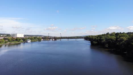 reverse shot of hudson river and train bridge receding into distance as height increases