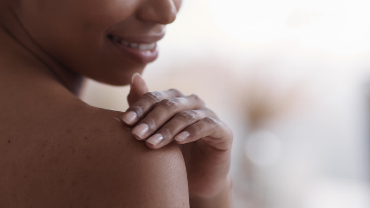 Woman touching her shoulder