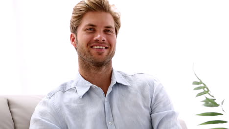 man watching tv and smiling