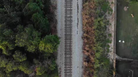 aerial: drone looking straight down at railroad tracks