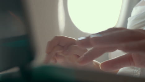 Woman-working-with-laptop-in-plane