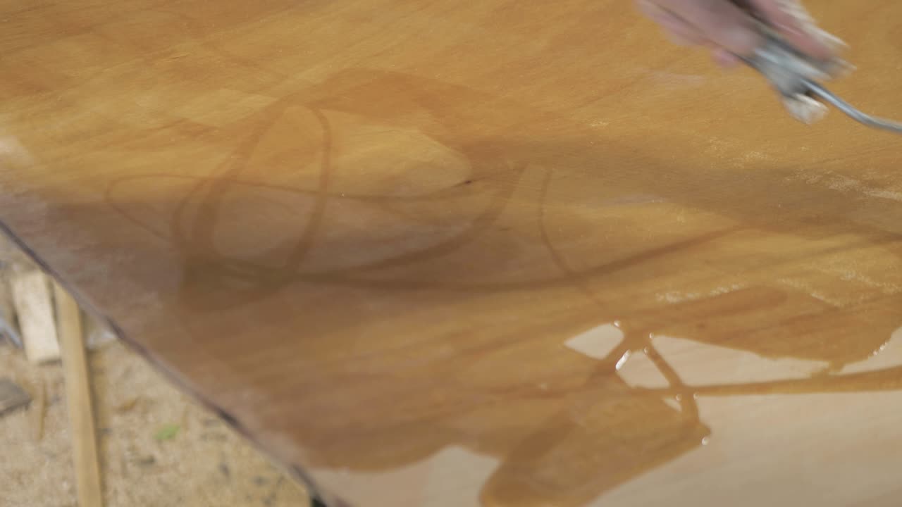 Spreading epoxy over plywood using roller