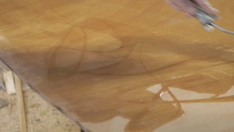 spreading epoxy over plywood using roller