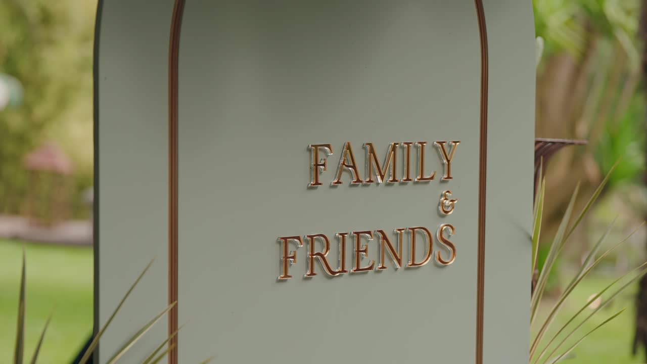 closeup of decorative sign reading family and friends in outdoor venue