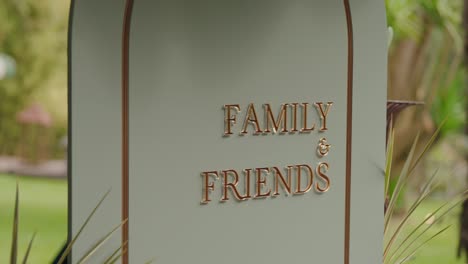 closeup of decorative sign reading family and friends in outdoor venue