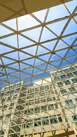 geometric ceiling in modern design. bright blue sky through a geometric glass ceiling in a modern building, highlighting urban design