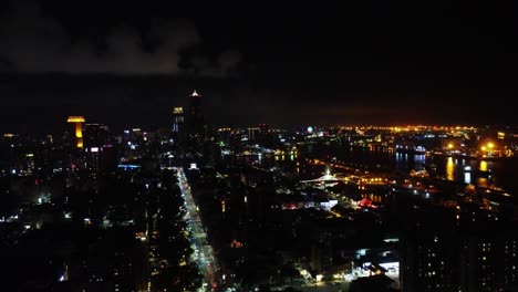 city skyline at night with illuminated streets and vibrant skyline, shot from high vantage point