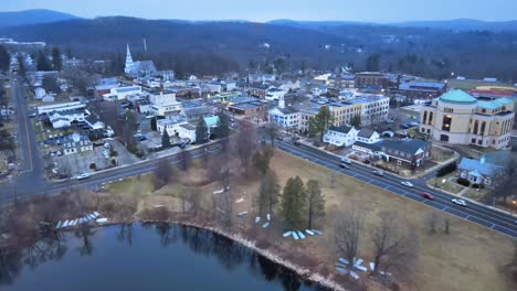 Aerial-footage-approaching-a-small-lake-town-in-america-just-after-sunset