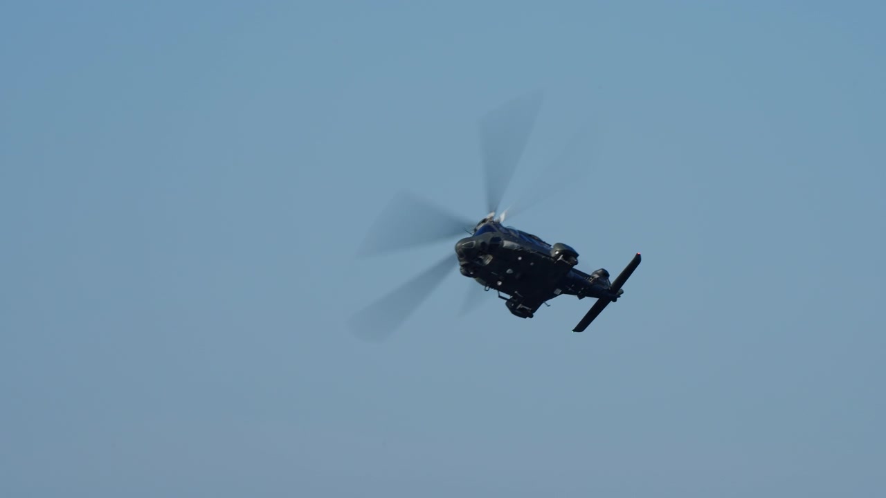 Military Helicopter Flying and Maneuvering in a Clear Blue Sky