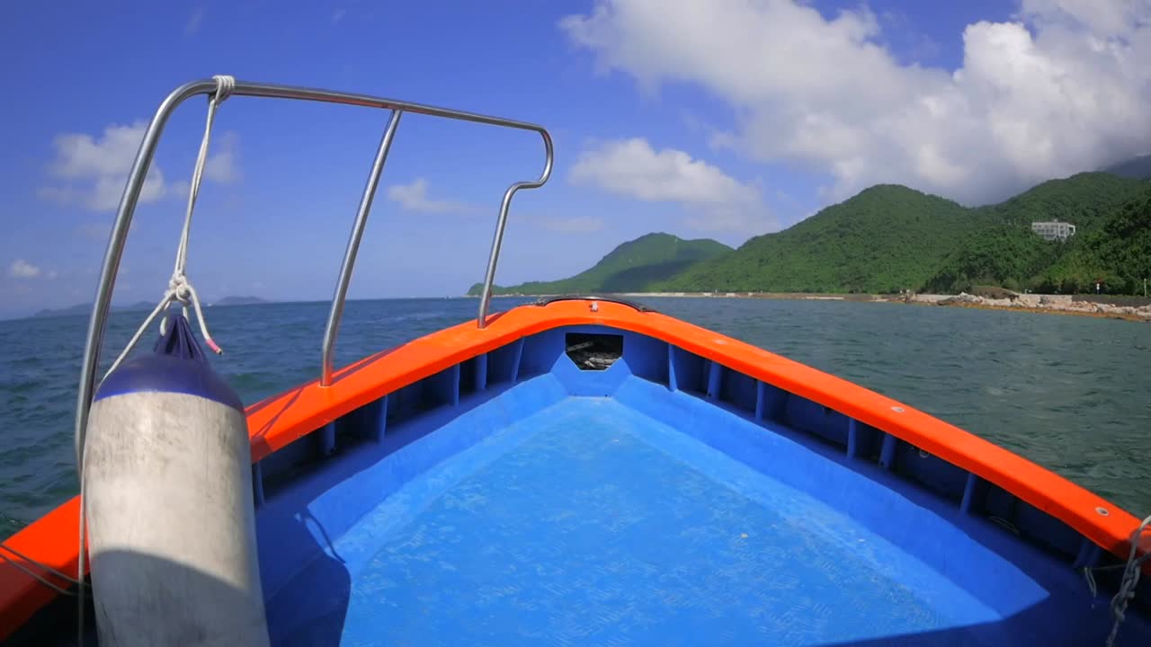 Cruising on a bumpy boat in a sea along the coast of breathtaking mountains