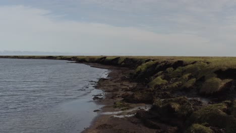 Aerial-Drone-Shot-Flying-Low-over-Melting-Permafrost-Eroding-into-the-Arctic-Ocean-from-Global-Warming-near-Barrow-Alaska