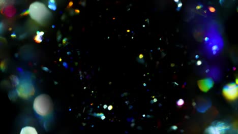 glitter star field rainbow bokeh prism background texture against black