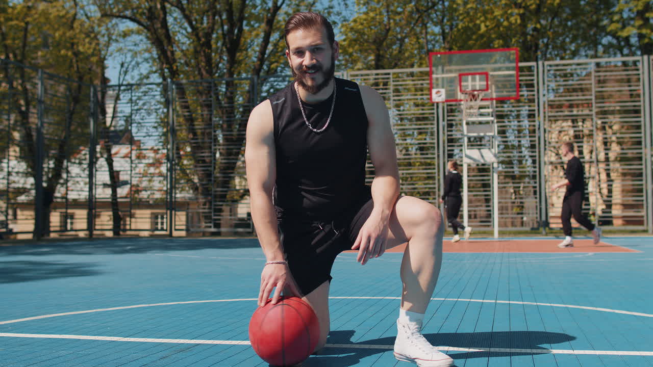 Portrait of tired smiling athletic lebanese man in sportswear relaxing after playing basketball game