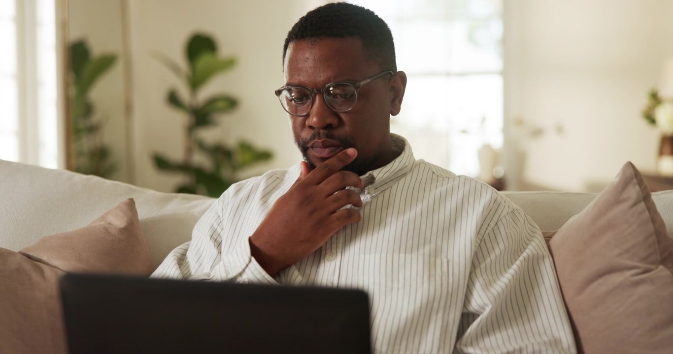 Focused Man Working on Laptop at Home
