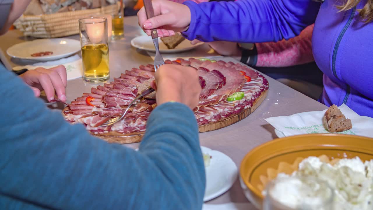 Friends enjoying an amazing charcuterie platter, delicious cured meats