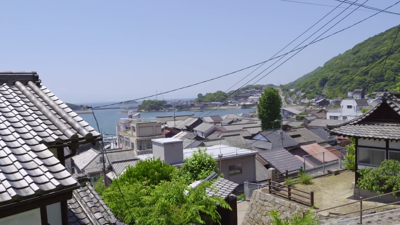 Panoramic sweeping shot over Tomonoura seaside fishing village in Japan