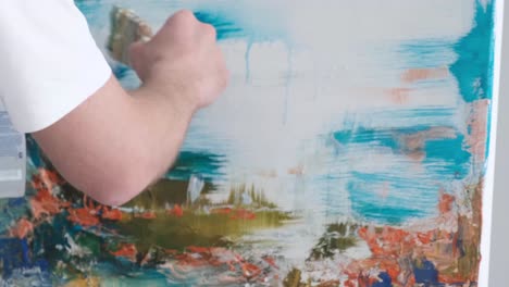 artist working on an abstract painting with spray bottle and brush