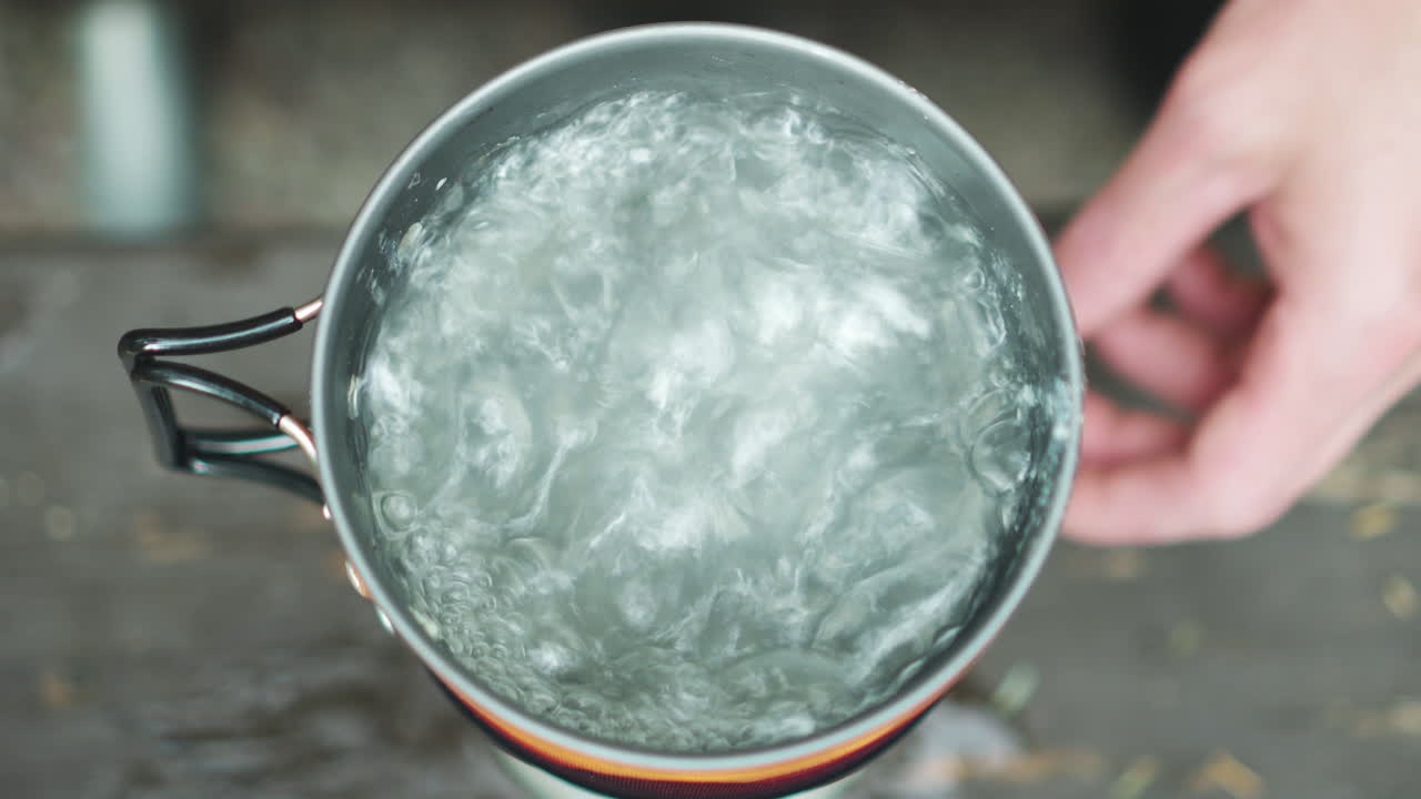 Closeup view 4k stock video footage of mug full of boiling water