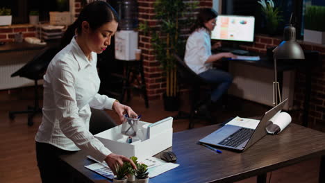 Frustrated-employee-packing-desk-belongings-after-being-fired,-saying-goodbye