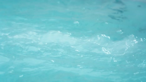 blue water in a jacuzzi spa hot tub, bubbles and roils in slow motion.