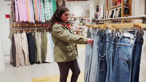 woman shopping for denim jeans in a clothing store