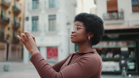 young woman smiling using smartphone outdoors