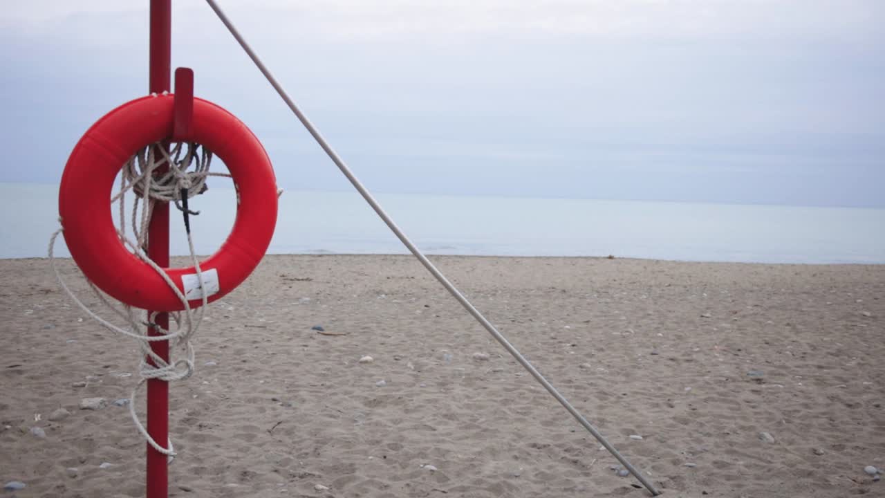 Lifeguard Lookout Post With Orange Lifebuoy Overlooking The Beach.- wide shot