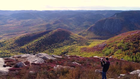 a guy takes photo of the rocky landscape